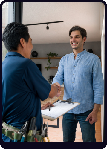 Technician greeting client at door shaking hands