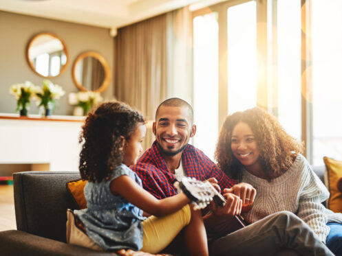 A young family relaxing comfortably in their Florida home